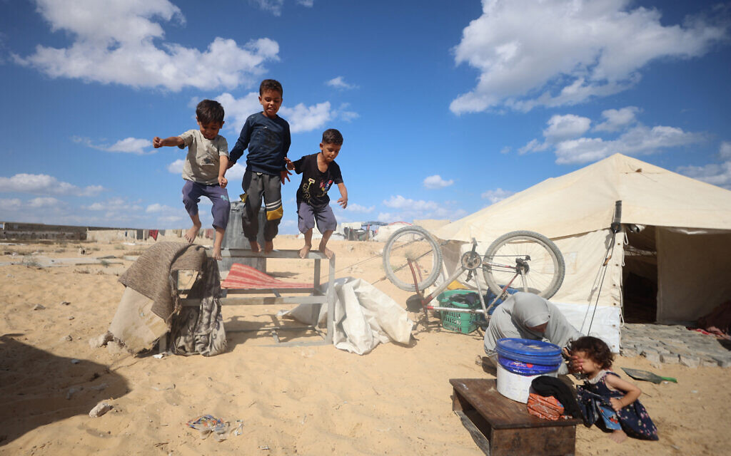Children play as displaced Palestinians set up temporary camp in the middle of a cemetery in Khan Younis in the southern Gaza Strip, on September 25, 2025. (Omar Al-Qattaa/AFP) Children play as displaced Palestinians set up temporary camp in the middle of a cemetery in Khan Younis in the southern Gaza Strip, on September 25, 2025. (Omar Al-Qattaa/AFP)