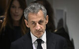 Former French president Nicolas Sarkozy leaves in front of his wife French-Italian singer Carla Bruni after the verdict in his trial for illegal campaign financing from Libya for his successful 2007 presidential bid, at the Tribunal de Paris courthouse in Paris, on September 25, 2025. (Julien De Rosa/AFP)