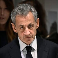 Former French president Nicolas Sarkozy leaves in front of his wife French-Italian singer Carla Bruni after the verdict in his trial for illegal campaign financing from Libya for his successful 2007 presidential bid, at the Tribunal de Paris courthouse in Paris, on September 25, 2025. (Julien De Rosa/AFP)
