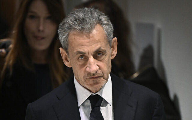 Former French president Nicolas Sarkozy leaves in front of his wife French-Italian singer Carla Bruni after the verdict in his trial for illegal campaign financing from Libya for his successful 2007 presidential bid, at the Tribunal de Paris courthouse in Paris, on September 25, 2025. (Julien De Rosa/AFP) Former French president Nicolas Sarkozy leaves in front of his wife French-Italian singer Carla Bruni after the verdict in his trial for illegal campaign financing from Libya for his successful 2007 presidential bid, at the Tribunal de Paris courthouse in Paris, on September 25, 2025. (Julien De Rosa/AFP)