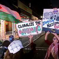 Anti-Israel activists hold signs calling to 'globalize the intifada' and comparing Zionism to Nazism during the 'Autonomous Noise Demonstration for Gaza' outside the hotel of Prime Minister Benjamin Netanyahu in New York City on September 25, 2025. (Leonardo Munoz/AFP)