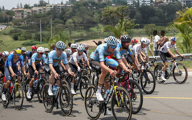 The pack of riders (peloton) cycle in the men's U23 road race cycling event during the UCI 2025 Road World Championships, in Kigali, on September 26, 2025. (Anne-Christine POUJOULAT / AFP)