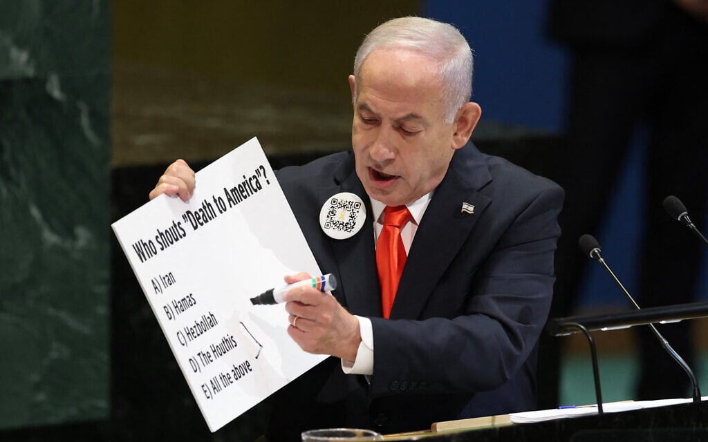 Prime Minister Benjamin Netanyahu holds a sign as he speaks during the General Debate of the United Nations General Assembly at UN headquarters in New York City on September 26, 2025. (Photo by ANGELA WEISS / AFP)