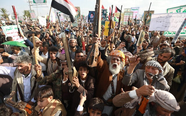 Yemenis, some carrying weapons, chant slogans during a rally in condemnation of Israeli strikes on Yemen and against Israel, in the Houthi-run capital Sanaa on September 26, 2025. (Mohammed HUWAIS / AFP)