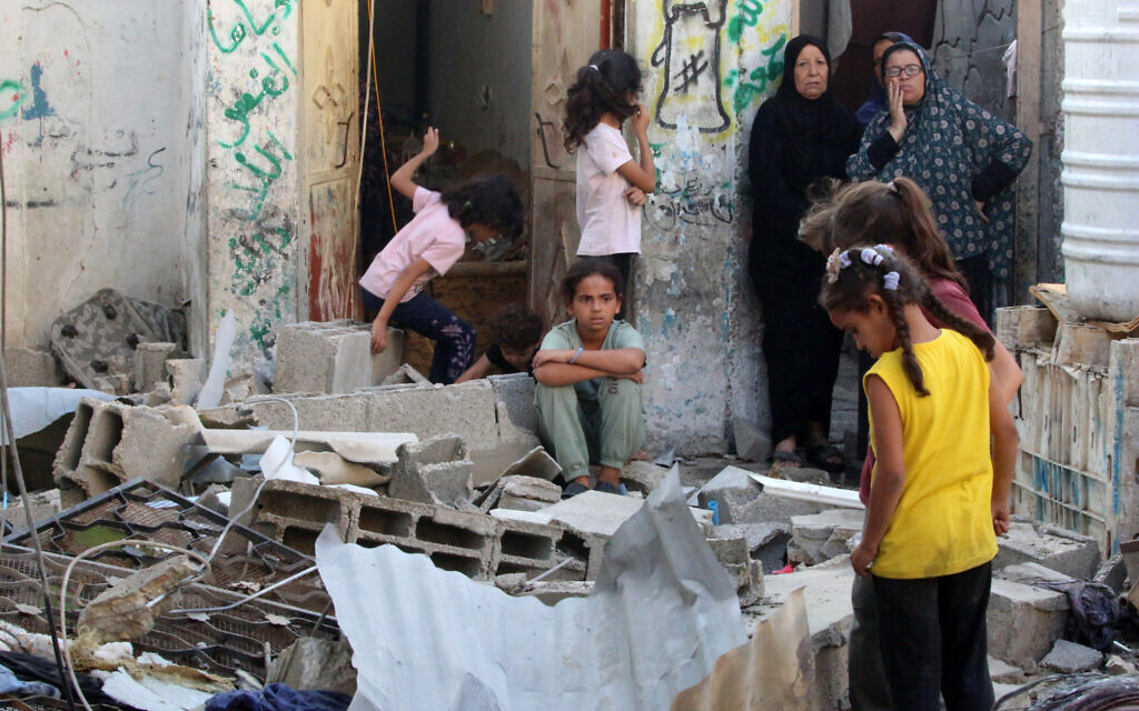 Palestinians check the damage outside a house hit by Israeli bombing in the Nuseirat refugee camp, in the central Gaza Strip, on September 27, 2025. (Eyad BABA / AFP)