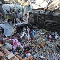 Palestinians check the damage outside a house hit by an Israeli strike in the Nuseirat  camp in the central Gaza Strip on September 27, 2025. (Photo by Eyad BABA / AFP)