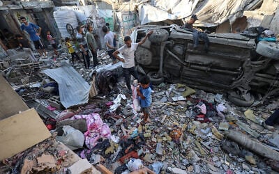 Palestinians check the damage outside a house hit by an Israeli strike in the Nuseirat  camp in the central Gaza Strip on September 27, 2025. (Photo by Eyad BABA / AFP)