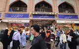Illustrative: Iranians walk past shops at the Grand Bazaar in Tehran on September 27, 2025. (ATTA KENARE / AFP)