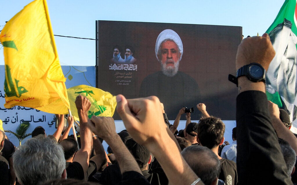 Hezbollah chief Naim Qassem addresses supporters through a screen in a televised address during a ceremony marking the first anniversary of Israel's assassination of the group's longtime leader Hassan Nasrallah in southern Lebanon on September 27, 2025. (Mahmoud Zayyat/AFP) Hezbollah chief Naim Qassem addresses supporters through a screen in a televised address during a ceremony marking the first anniversary of Israel's assassination of the group's longtime leader Hassan Nasrallah in southern Lebanon on September 27, 2025. (Mahmoud Zayyat/AFP)
