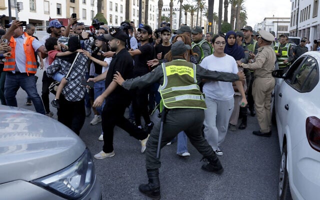 Moroccan security forces escort protesters away from the parliament building in Rabat on September 28, 2025, during a youth-led demonstration for social justice and improvements to the public health and education sectors. (Abdel Majid BZIOUAT/AFP)