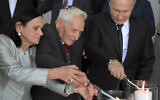 Russian President Vladimir Putin, right, and Aron Bell, center, light candles at an unveiling ceremony of a monument to the Heroes of Resistance at Nazi concentration camps and Jewish ghettos during the World War II, at the Jewish Museum and Tolerance Center in Moscow, Russia, June 4, 2019. (Alexei Druzhinin, Sputnik, Kremlin Pool Photo via AP)