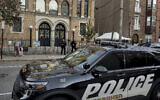 Hoboken Police officers stand watch outside the United Synagogue of Hoboken, Thursday, Nov. 3, 2022, in Hoboken, N.J., after the FBI's Newark office released a statement that characterizes it as a broad threat, urging synagogues to "take all security precautions to protect your community and facility." . (AP Photo/Ryan Kryska, File)