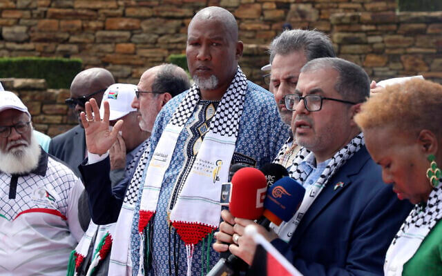 Hamas official Basem Naim, second right, speaks to journalist as Nelson Mandela's grandson Mandla Mandela, center, watches on during a march to commemorate the 10th Anniversary of the death of former South African president Nelson Mandela at Union Building in Pretoria, South Africa, Dec. 5, 2023 (AP Photo)