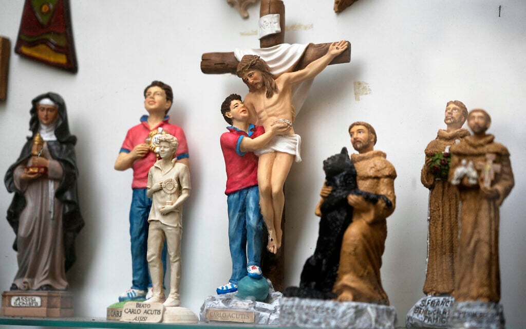 Statuettes of Carlo Acutis, an Italian boy who died in 2006 of leukemia, are displayed in a shop in Assisi, Italy, on March 1, 2025. (AP Photo/Gregorio Borgia)