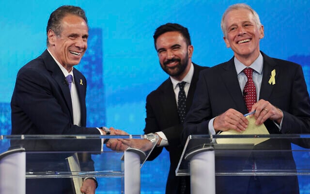 Democratic New York City mayoral candidates Andrew Cuomo, left, shakes hands with Zohran Mamdani, center, as Whitney Tilson reacts after participating in a Democratic mayoral primary debate, June 4, 2025, in New York. (AP Photo/Yuki Iwamura, Pool)