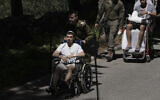 Wounded IDF soldiers arrive for the funeral of a comrade at Mt. Herzl Military Cemetery in Jerusalem, July 8, 2025. (AP Photo/Maya Alleruzzo)