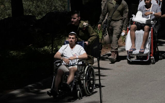 Wounded IDF soldiers arrive for the funeral of a comrade at Mt. Herzl Military Cemetery in Jerusalem, July 8, 2025. (AP Photo/Maya Alleruzzo) Wounded IDF soldiers arrive for the funeral of a comrade at Mt. Herzl Military Cemetery in Jerusalem, July 8, 2025. (AP Photo/Maya Alleruzzo)