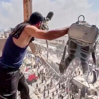 This frame grab taken from a video released by Reuters shows a man holding a journalist's camera equipment at Nasser Hospital shortly after the first of two rounds of Israeli strikes hit Nasser Hospital in Khan Younis, in the southern Gaza Strip, on August 25, 2025. (Reuters via AP)