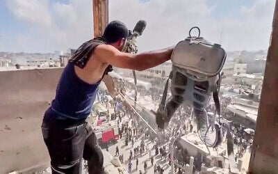 This frame grab taken from a video released by Reuters shows a man holding a journalist's camera equipment at Nasser Hospital shortly after the first of two rounds of Israeli strikes hit Nasser Hospital in Khan Younis, in the southern Gaza Strip, on August 25, 2025. (Reuters via AP)