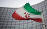A national flag of Iran waves in front of the building of the International Atomic Energy Agency, IAEA, in Vienna, Austria, December 17, 2021. (AP Photo/Michael Gruber, File)