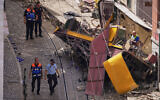 Police officers inspect the site where a tourist streetcar derailed and crashed in Lisbon, Portugal, Thursday, Sept. 4, 2025. (AP/Armando Franca)