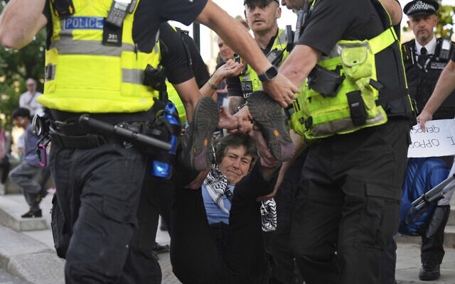 Police officers carry a protester during a protest to support Palestine Action in London, Saturday, Sept. 6, 2025.(AP Photo/Joanna Chan)