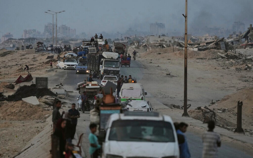 Displaced Palestinians fleeing northern Gaza carry their belongings along the coastal road toward southern Gaza, Saturday, Sept. 6, 2025. (AP/Jehad Alshrafi)