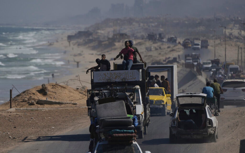 Displaced Palestinians fleeing northern Gaza carry their belongings along the coastal road toward southern Gaza, Tuesday, September 9, 2025, after the Israeli army issued evacuation orders from Gaza City. (AP/Jehad Alshrafi)