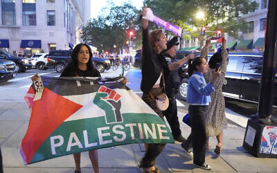 Pro-Palestinian protesters gather near a restaurant entrance after US President Donald Trump arrived for dinner near the White House, September 9, 2025, in Washington. (AP Photo/Alex Brandon)