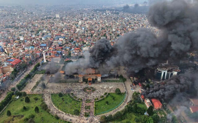 Protesters celebrate at the Singha Durbar, the seat of Nepal's government's various ministries and offices, after it was set on fire during a protest against social media ban and corruption in Kathmandu, Nepal, Tuesday, Sept. 9, 2025. (AP Photo/Prakash Timalsina) Protesters celebrate at the Singha Durbar, the seat of Nepal's government's various ministries and offices, after it was set on fire during a protest against social media ban and corruption in Kathmandu, Nepal, Tuesday, Sept. 9, 2025. (AP Photo/Prakash Timalsina)