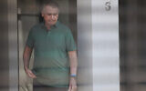 Brazil's former president Jair Bolsonaro stands at the entrance of his home where he is under house arrest in Brasilia, Brazil, September 11, 2025. (AP Photo/Luis Nova)