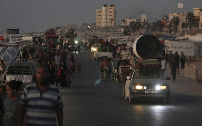 Displaced Palestinians fleeing northern Gaza after Israeli evacuation orders carry their belongings along the coastal road in Zawaida, central Gaza Strip, September 12, 2025. (AP Photo/Abdel Kareem Hana)