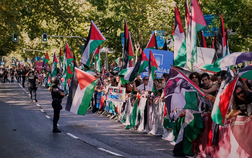 People hold Palestinian flags while protesting during the twenty-first stage of La Vuelta cycling race from Alalpardo to Madrid, Spain, on September 14, 2025. (AP/Andrea Comas) People hold Palestinian flags while protesting during the twenty-first stage of La Vuelta cycling race from Alalpardo to Madrid, Spain, on September 14, 2025. (AP/Andrea Comas)