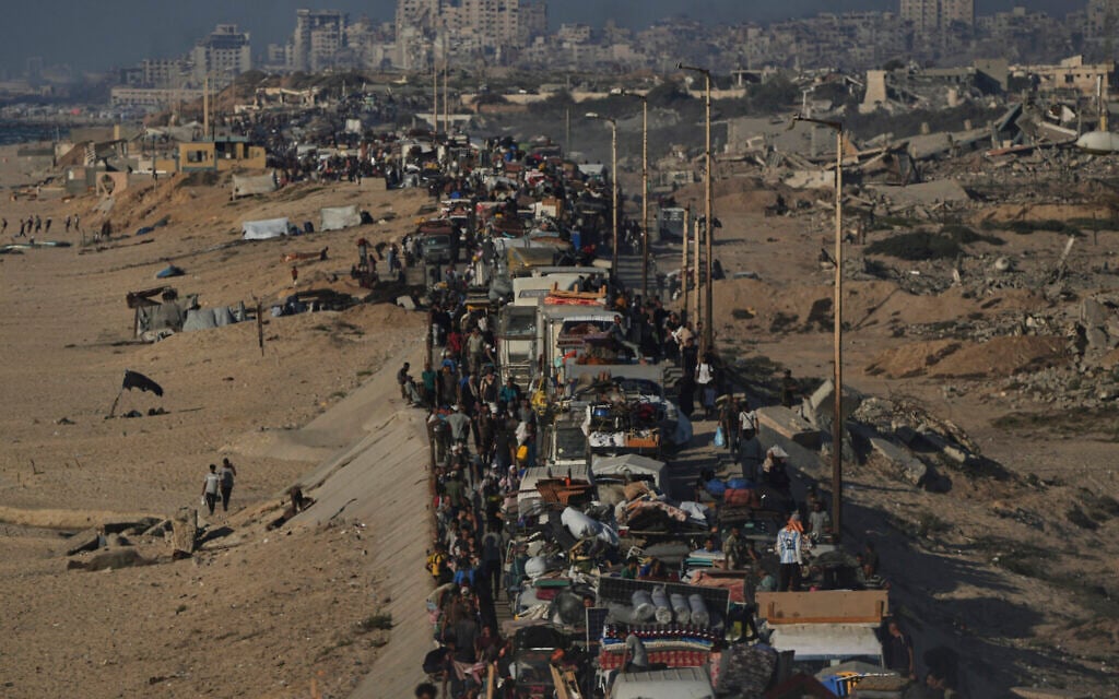 Displaced Palestinians flee northern Gaza by foot and in vehicles along the coastal road toward southern Gaza, Sunday, September 14, 2025. (AP/Abdel Kareem Hana)