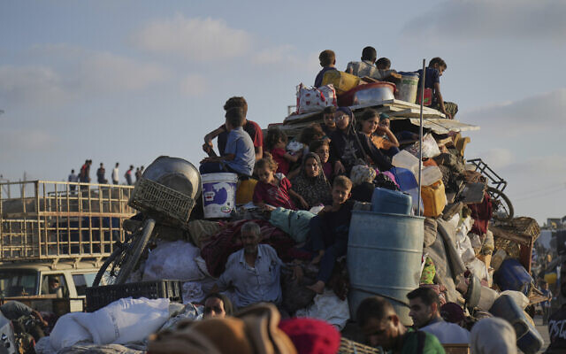 Displaced Palestinians flee northern Gaza by foot and in vehicles, carrying their belongings along the coastal road toward the south of the Strip on September 15, 2025. (AP/Abdel Kareem Hana)
