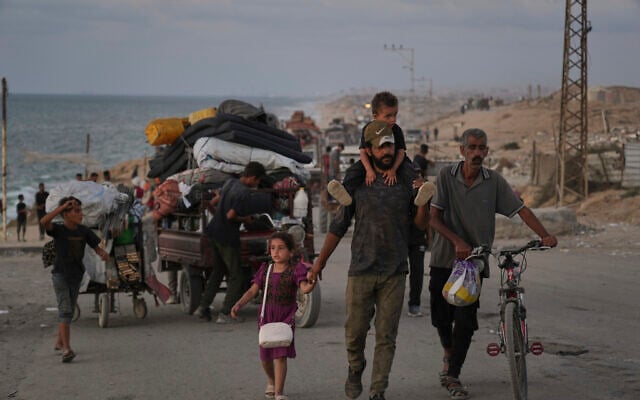 Displaced Palestinians flee northern Gaza along the coastal road toward the south, as Israel announced an expanded operation in Gaza City, Tuesday, Sept. 16, 2025. (AP/Abdel Kareem Hana)