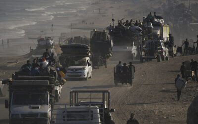 Displaced Palestinians flee Gaza City on foot and in vehicles, carrying their belongings along the coastal road toward southern Gaza, September 17, 2025. (AP/Abdel Kareem Hana)