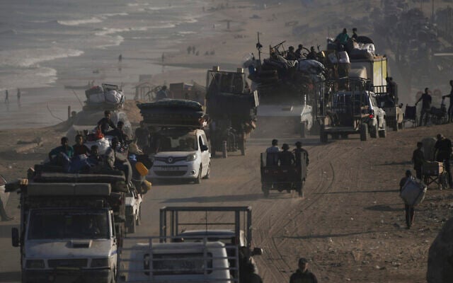 Displaced Palestinians flee Gaza City on foot and in vehicles, carrying their belongings along the coastal road toward southern Gaza, September 17, 2025. (AP/Abdel Kareem Hana)