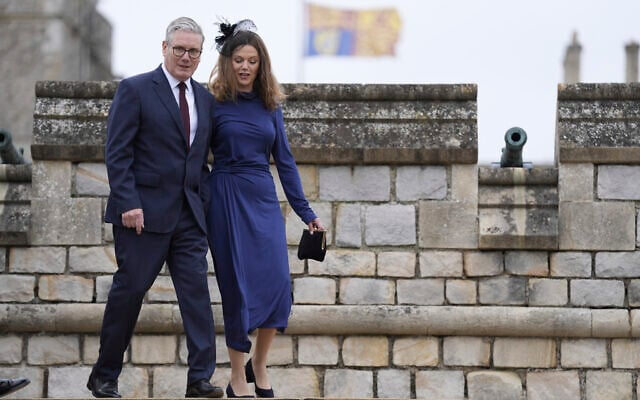 British Prime Minister Sir Keir Starmer and wife, Lady Victoria Starmer, arrive for the Beating Retreat military ceremony at Windsor Castle, England, on Wednesday Sept. 17, 2025, on day one of US President Donald Trump's second state visit to the UK. (Andrew Matthews/PA via AP, Pool)