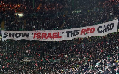Celtic fans lift a protest banner about Israel during the UEFA Champions League playoff first leg soccer match between Glasgow Celtic and Bayern Munich at the Celtic Park Stadium in Glasgow, Scotland on February 12, 2025. (AP/Scott Heppell)