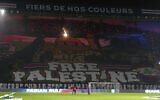A giant banner reading 'Free Palestine' is displayed before the Champions League opening phase soccer match between Paris Saint Germain and Atletico Madrid at the Parc des Princes stadium in Paris on November 6, 2024. (AP/Michel Euler)