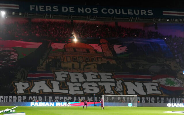 A giant banner reading 'Free Palestine' is displayed before the Champions League opening phase soccer match between Paris Saint Germain and Atletico Madrid at the Parc des Princes stadium in Paris on November 6, 2024. (AP/Michel Euler) A giant banner reading 'Free Palestine' is displayed before the Champions League opening phase soccer match between Paris Saint Germain and Atletico Madrid at the Parc des Princes stadium in Paris on November 6, 2024. (AP/Michel Euler)