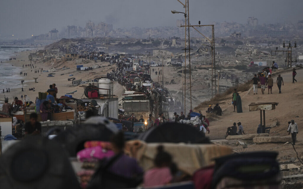 Displaced Palestinians flee Gaza City by foot and vehicles, carrying their belongings along the coastal road toward southern Gaza, September 18, 2025. (AP Photo/Abdel Kareem Hana)