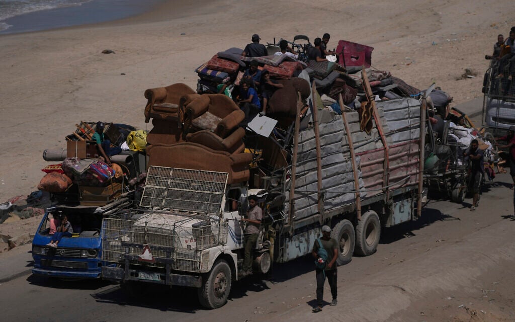 Displaced Palestinians flee northern Gaza Strip, by foot and in vehicles, carrying their belongings along the coastal road, near Wadi Gaza, September 20, 2025. (AP Photo/Abdel Kareem Hana)