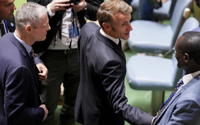 French President Emmanuel Macron, center, greets delegates upon arriving inside the United Nations General Assembly Hall, Monday, Sept. 22, 2025, at UN headquarters. (AP Photo/Angelina Katsanis)