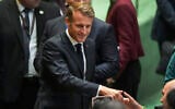 French President Emmanuel Macron greets delegates upon arriving inside the UN General Assembly hall, September 22, 2025, at UN headquarters. (AP Photo/Angelina Katsanis)