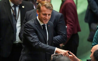 French President Emmanuel Macron greets delegates upon arriving inside the UN General Assembly hall, September 22, 2025, at UN headquarters. (AP Photo/Angelina Katsanis)
