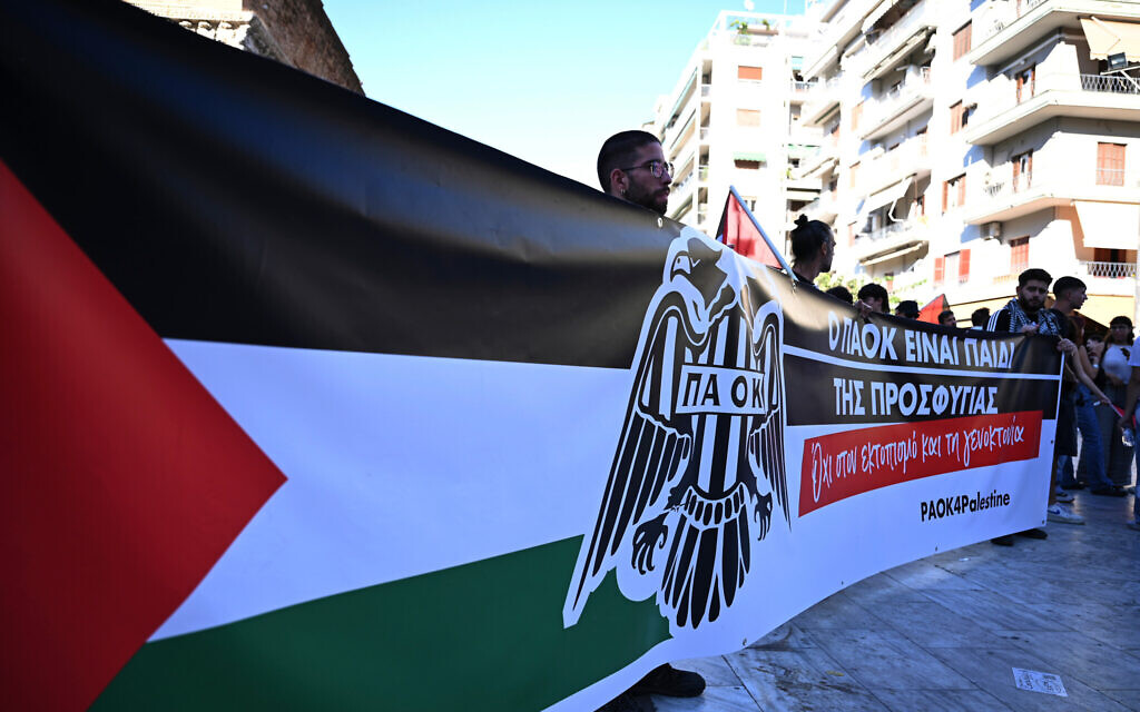 Pro-Palestinian protesters hold a banner that reads "PAOK is the child of refugees. No to displacement and genocide" as they gather ahead of a Europa League soccer match between PAOK and Israeli team Maccabi Tel Aviv in the port city of Thessaloniki, northern Greece, Wednesday, Sept. 24, 2025. (AP/Giannis Papanikos)