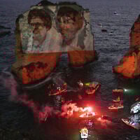 Portraits of former Hezbollah leaders Hassan Nasrallah, right, and Hashem Safieddine, projected onto the landmark Raouche sea rock during an event commemorating their deaths in Israeli airstrikes nearly a year ago, in Beirut, Lebanon, September 25, 2025. (AP/Hussein Malla)