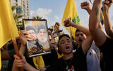 Hezbollah supporters shout slogans during an event commemorating the anniversary of the assassination of Hezbollah leader Hassan Nasrallah in Beirut, Lebanon, September 25, 2025. (AP Photo/Hussein Malla)